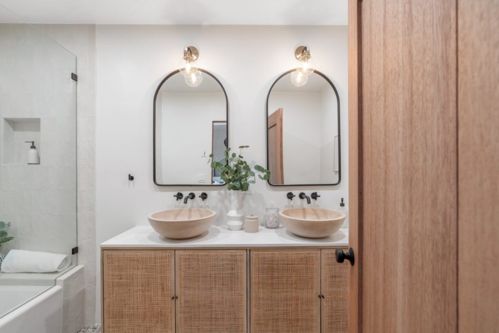 tiled bathroom with two mirrors